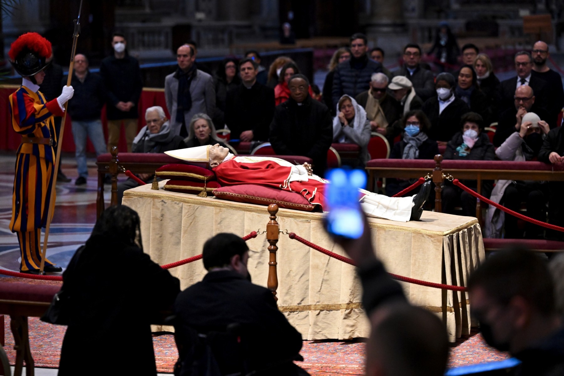 Des dizaines de milliers de fidèles ont défilé lundi sous les ors de la basilique Saint-Pierre de Rome pour se recueillir devant la dépouille de Benoît XVI, mort samedi à 95 ans et dont les funérailles seront célébrées jeudi par le pape François (Photo, AFP)