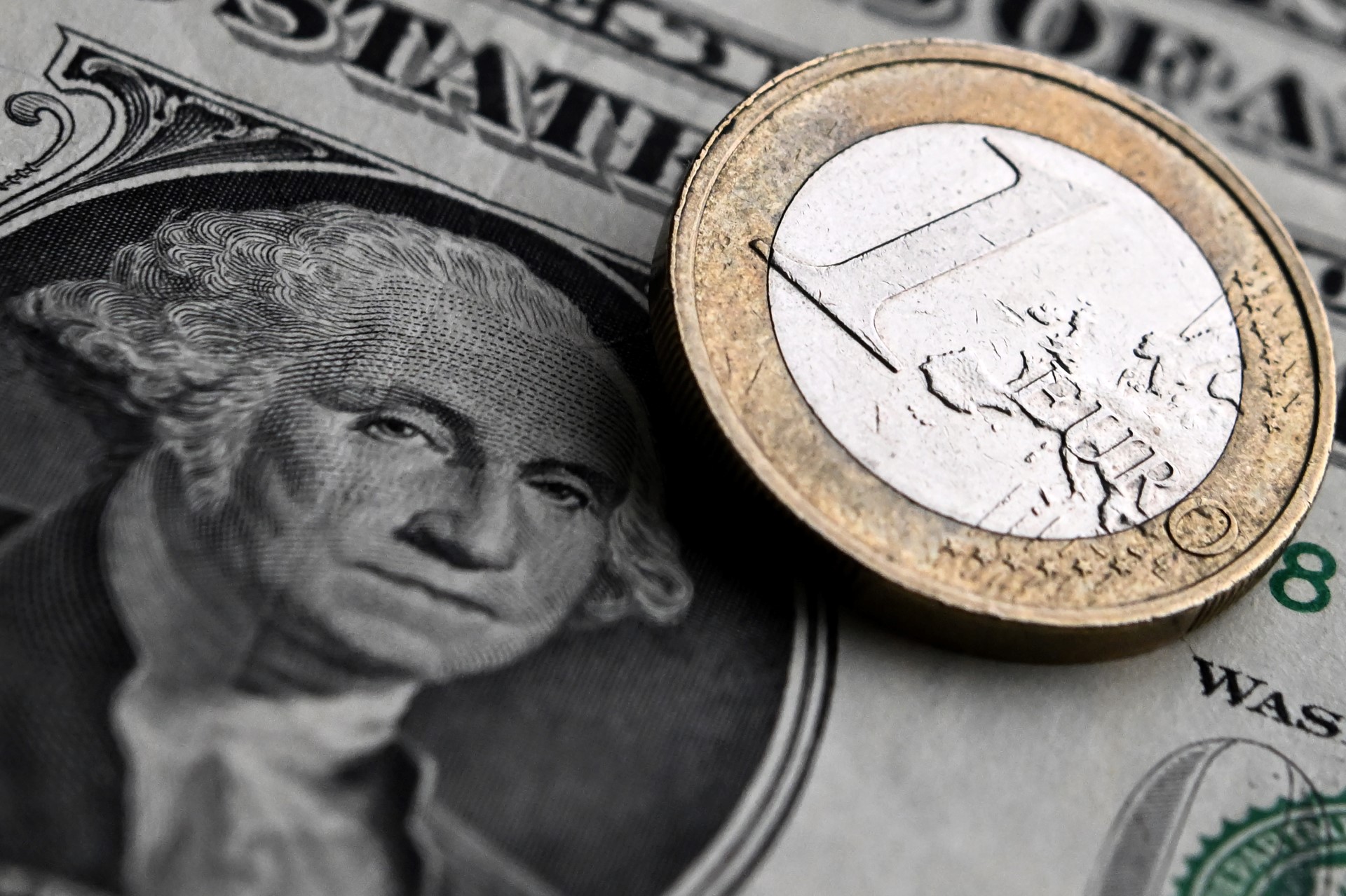 Cette photo prise le 9 février 2023 montre une pièce d'euro et des billets de banque en dollars américains. (Photo de Kirill Kudryavtsev / AFP