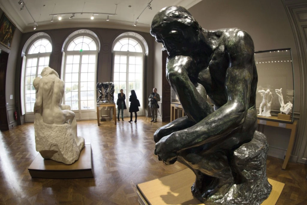 La sculpture en bronze "Le Penseur" (à droite) est photographiée à côté de la sculpture en marbre "Le Baiser" du sculpteur français Auguste Rodin (1840 - 1917) à l'Hôtel Biron qui abrite le Musée Rodin à Paris, en novembre 2015. (Joel Saget/AFP)