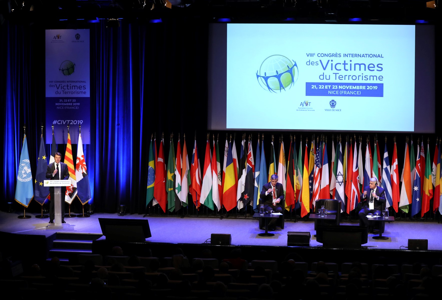 Le maire de Nice Christian Estrosi (à gauche) prononce un discours entouré du directeur général de l'Association française des victimes du terrorisme (AfVT) Guillaume Denoix de Saint Marc (au centre) et du directeur et adjoint du secrétaire général adjoint au Bureau des Nations Unies pour la lutte contre le terrorisme (UNOCT) Raffi Gregorian (à droite) lors de la cérémonie d'ouverture du "VIIIe Congrès international des victimes du terrorisme", le 21 novembre 2019, à Nice. (Valery Hache/AFP)