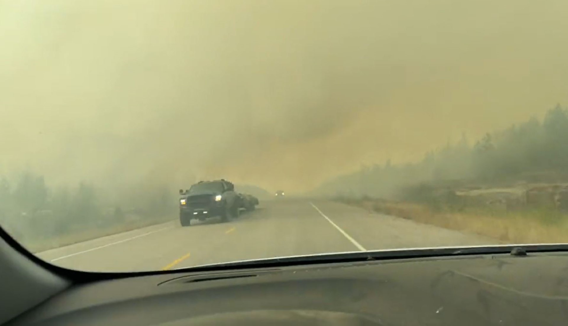 Cette capture d'écran d'une vidéo fournie par Jordan Straker montre des véhicules circulant sur l'autoroute alors que des personnes évacuent Yellowkife, dans les Territoires du Nord-Ouest, au Canada, le 16 août 2023. (Photo par Jordan Straker / UGC / AFP)