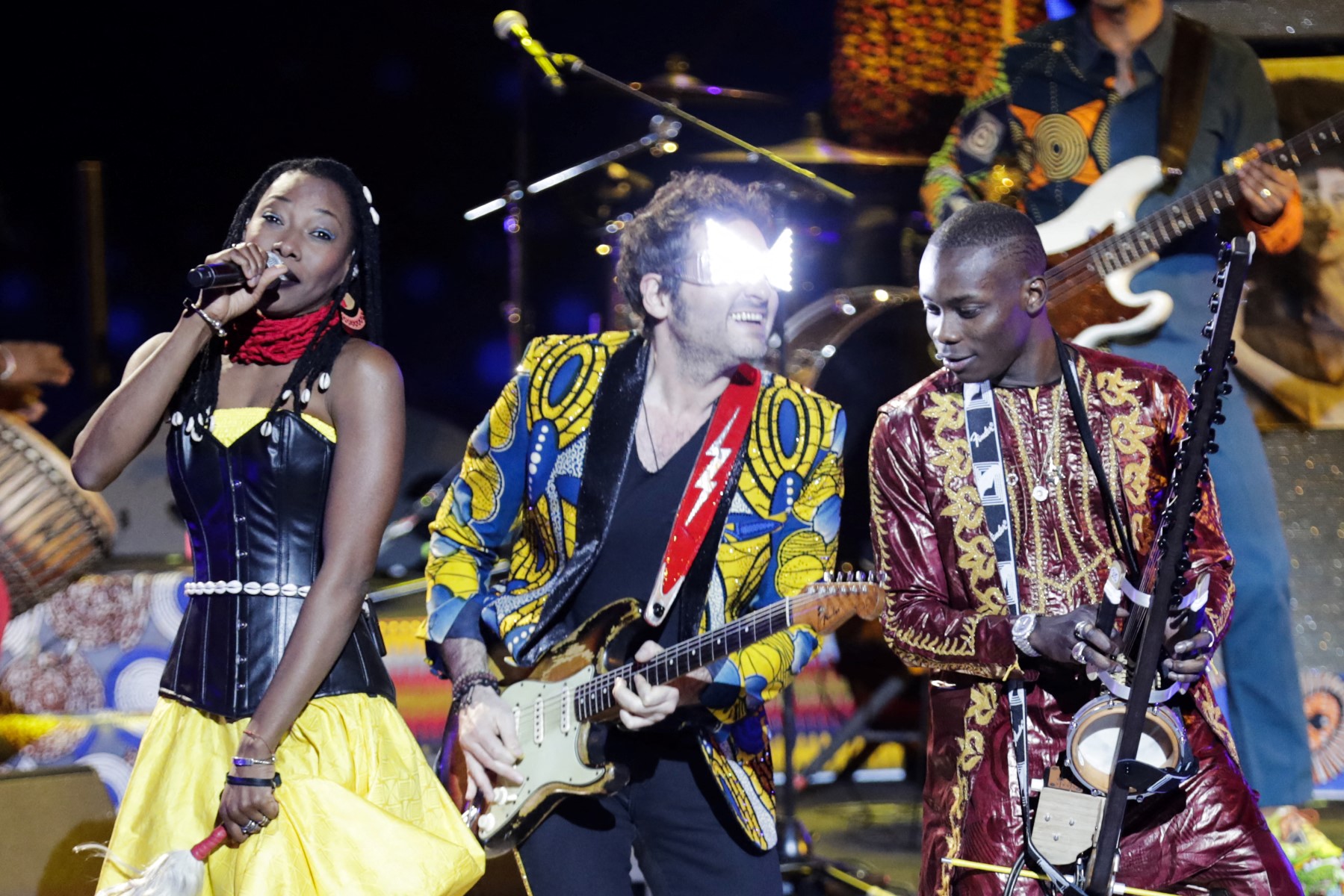 L'auteur, chanteur, musicien et compositeur français Matthieu Chedid alias -M- (au centre), la chanteuse malienne Fatoumata Diawara (à gauche) et le musicien et chanteur malien Sidiki Diabate (à droite) se produisent sur scène lors des 33e Victoires de la Musique, la cérémonie annuelle de remise des prix de la musique française, le 9 février 2018 à la salle de concert Seine Musicale à Boulogne-Billancourt, en banlieue parisienne. (Photo par Thomas Samson / AFP)