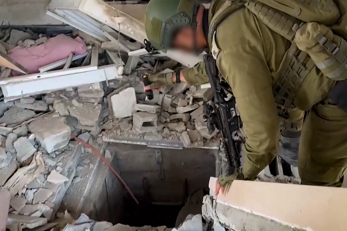 Cette capture d'écran tirée d'une vidéo diffusée par l'armée israélienne le 3 novembre 2023 montre un soldat israélien vérifiant ce qu'il dit être l'entrée d'un tunnel utilisé par le mouvement palestinien Hamas dans la bande de Gaza, alors que les batailles entre les forces israéliennes et le Hamas se poursuivent. (Photo de l'armée israélienne / AFP)