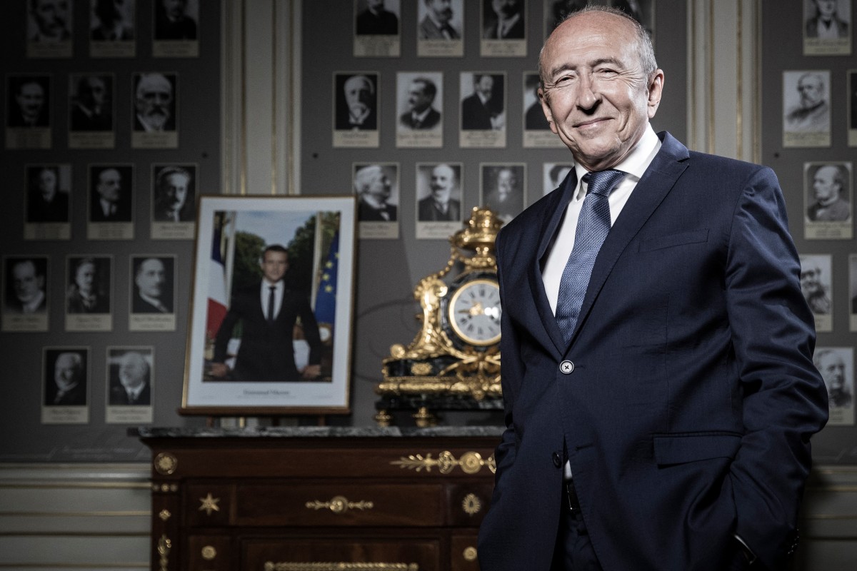 Sur cette photo prise le 24 août 2018, le ministre français de l'Intérieur Gérard Collomb, pose à côté d'un portrait officiel du président français Emmanuel Macron, lors d'une séance photo dans son bureau au ministère de l'Intérieur, place Beauvau, à Paris. Gérard Collomb, ancien maire de Lyon et ministre de l'Intérieur, est décédé à l'âge de 76 ans, a indiqué son entourage le 25 novembre 2023. (Photo Joel Saget AFP)