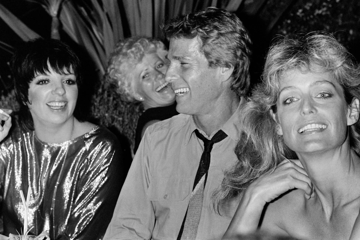 Cette photo prise le 22 juillet 1982 montre l'actrice américaine Farrah Fawcett (à droite) accompagnée de son mari l'acteur Ryan O'Neal (au centre) et de la chanteuse et actrice américaine Liza Minnelli (à gauche) lors d'une soirée au "Manoa" à Monaco. (Photo Ralph Gatti AFP)