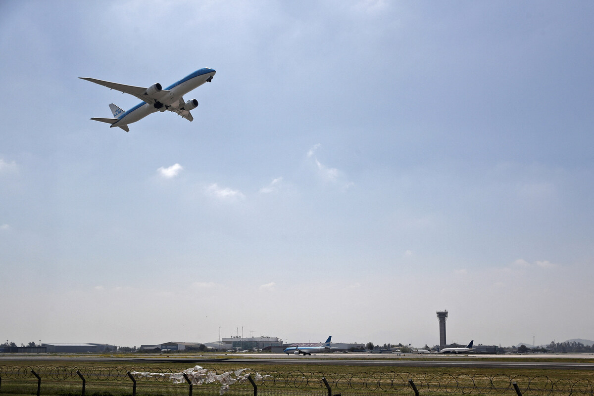 Un passager ouvre la porte de l'avion et marche sur l'une de ses ailes