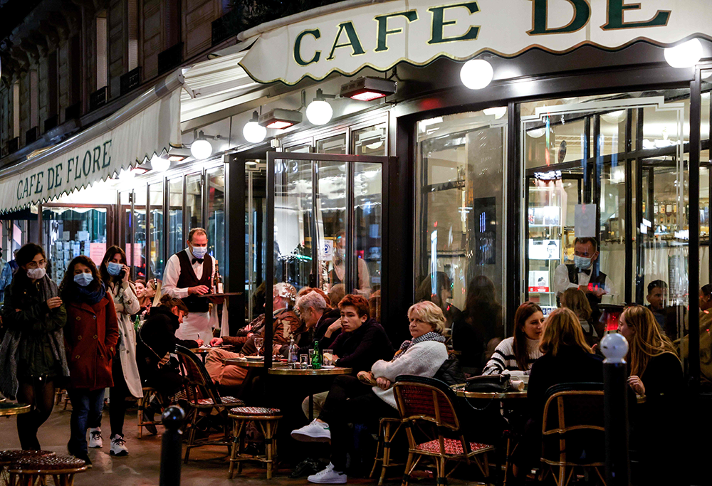 People share drinks at the terrace of the "Cafe de Flore" in Paris on Oct. 26, 2020. (AFP)