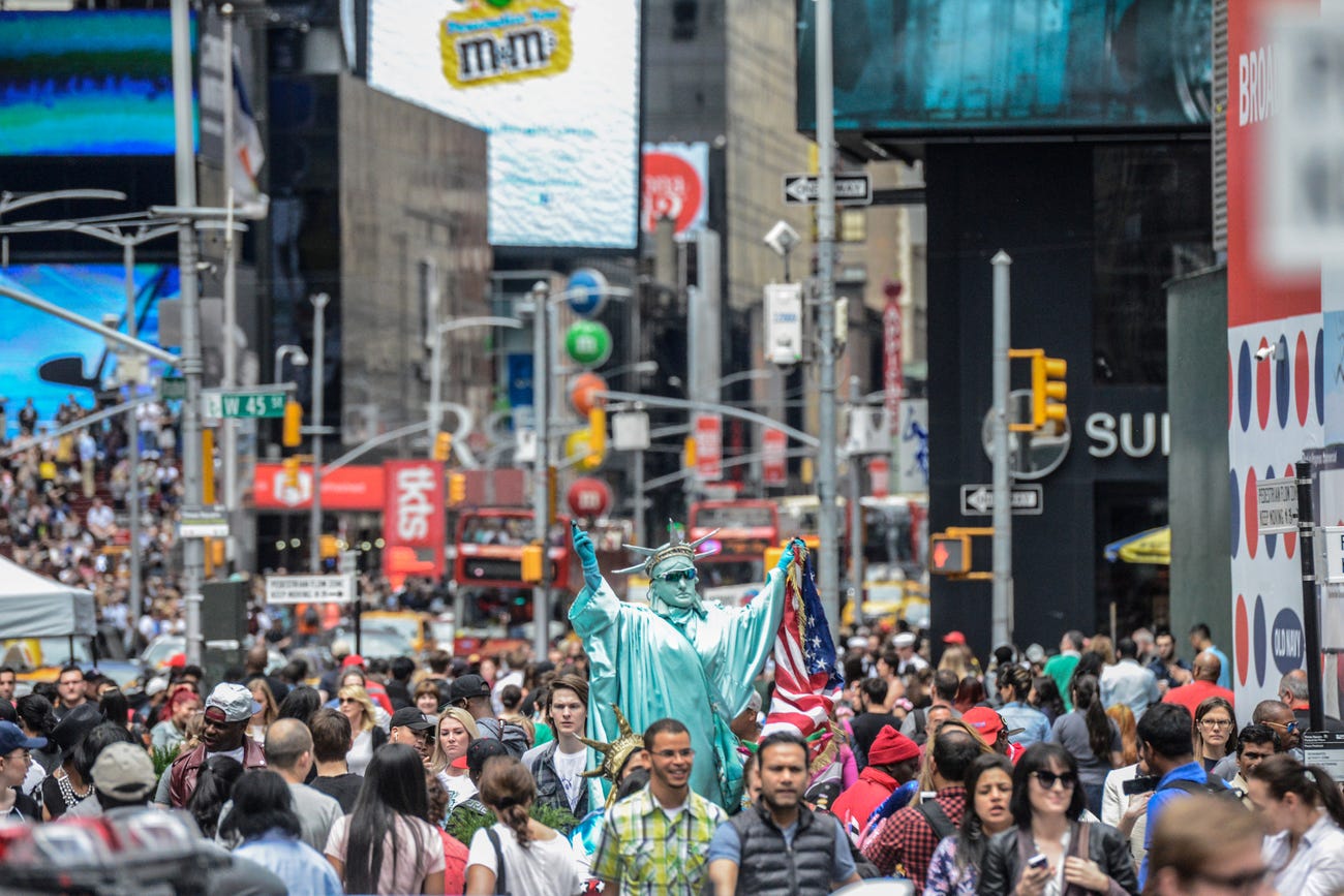Pedestrians move through Times Square in New York City. (Reuters)