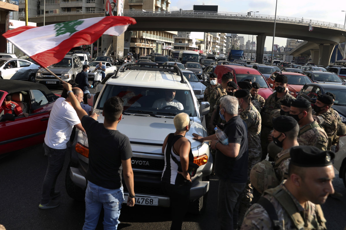 Lebanese army soldiers stand guard as protesters block a main highway leading to Beirut, Lebanon, on June 24, 2021. (AP Photo/Bilal Hussein)