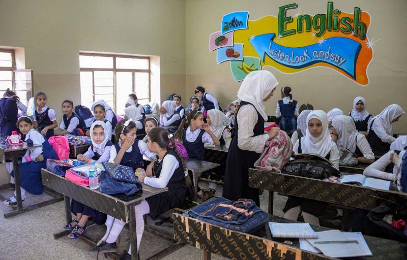 Iraqi schoolgirls attend an English class at a school in western Mosul. (AFP)