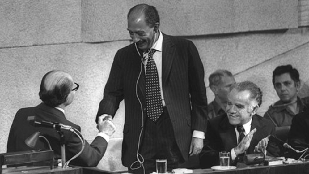 Anwar Sadat shakes hands with Menachem Begin, after his speech to the Knesset, in 1977. (Getty Images)