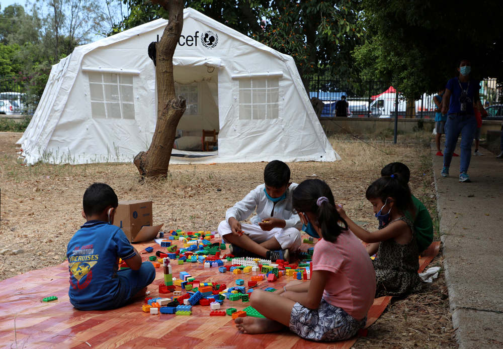 Children play outside a UNICEF tent following a massive explosion in Beirut's port area, Lebanon, Aug. 20, 2020. (Reuters)