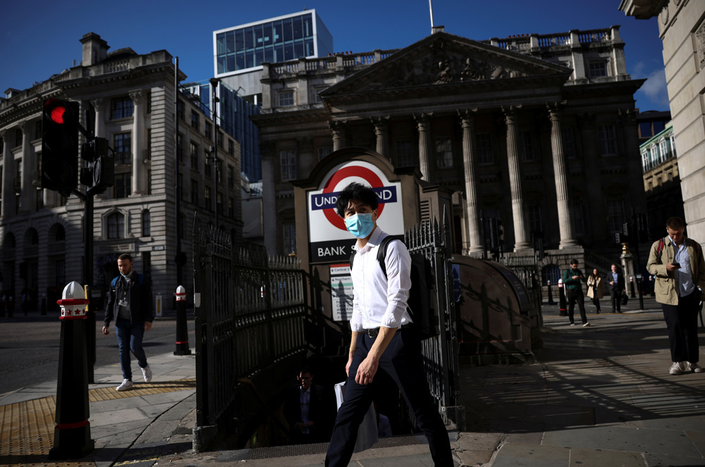 A person walks past Bank underground station during morning rush hour, amid the COVID-19 pandemic in London, Britain, July 29, 2021. (Reuters)