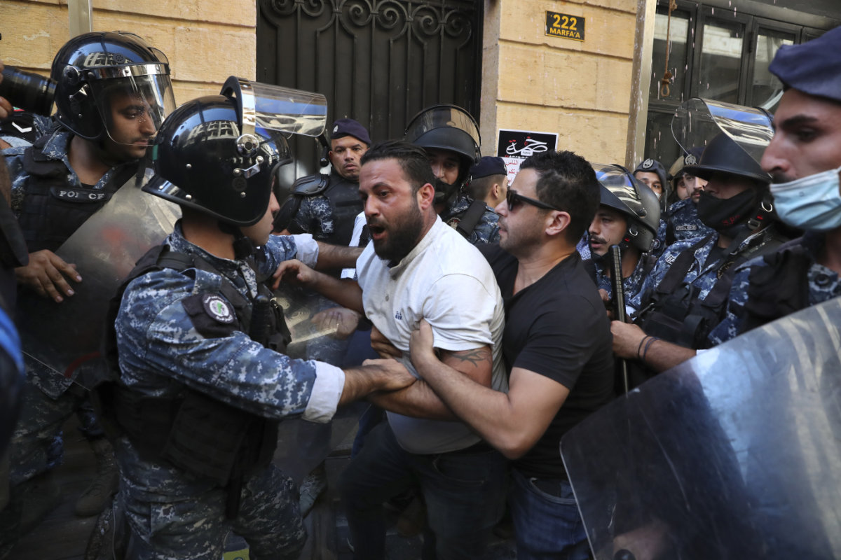 Customers scuffle with riot police as they try to storm a bank in Beirut, Lebanon, on Oct. 6, 2021. (AP/File)