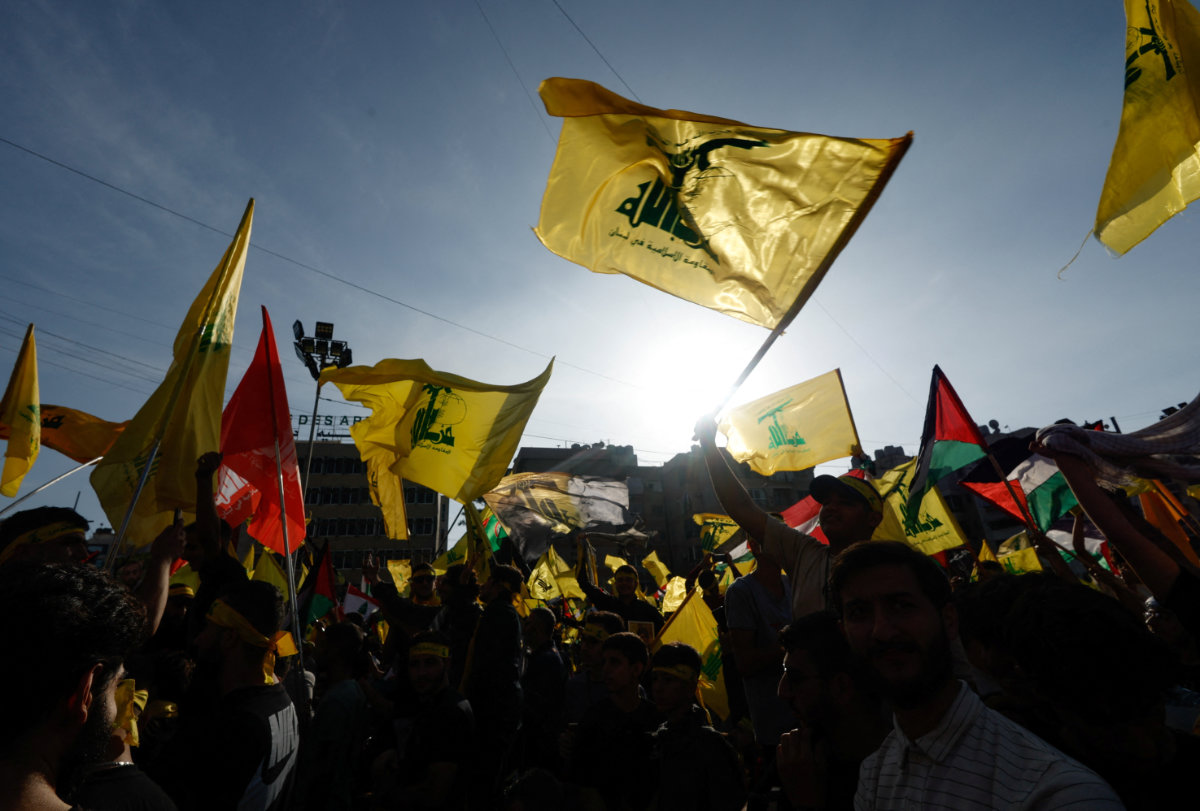 Hezbollah supporters gather outside Beirut gather to watch Sayyed Hassan Nasrallah speak during a ceremony on Friday. (REUTERS)