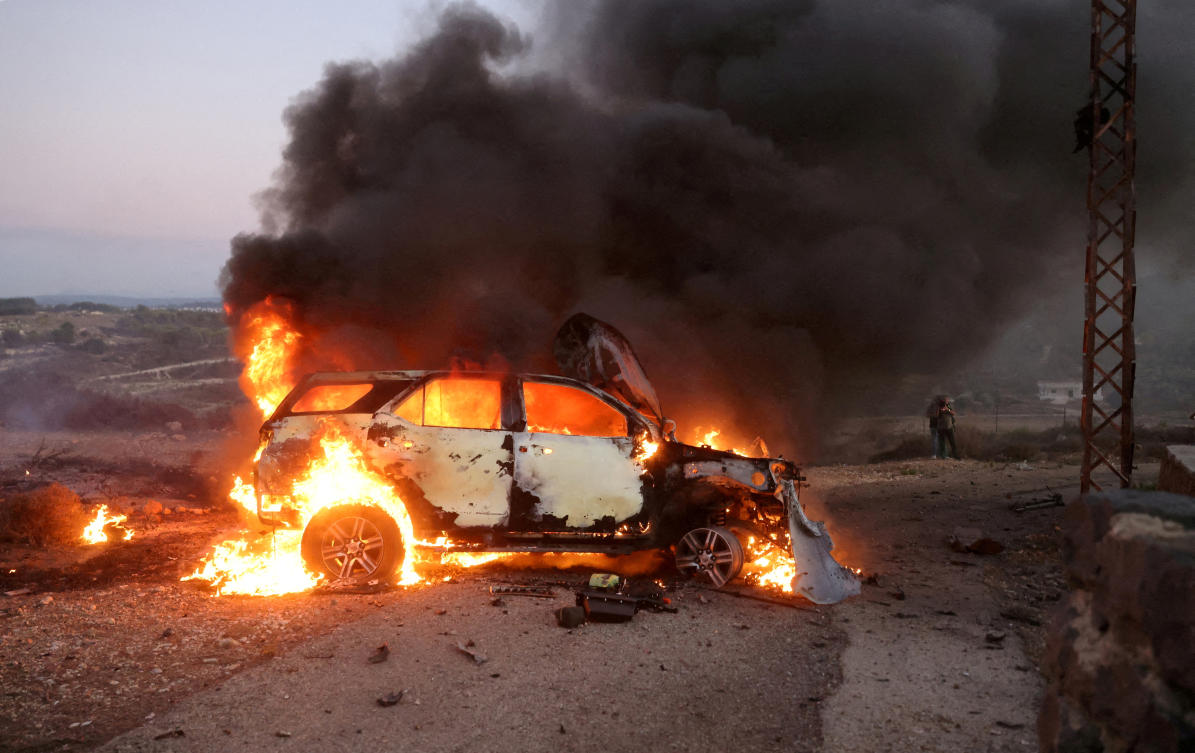 Car belonging to an Al Jazeera team burns at the site where Reuters visuals journalist Issam Abdallah was killed and six others were wounded by two tank rounds fired from Israel near the border with Israel, southern Lebanon. (File/Reuters)