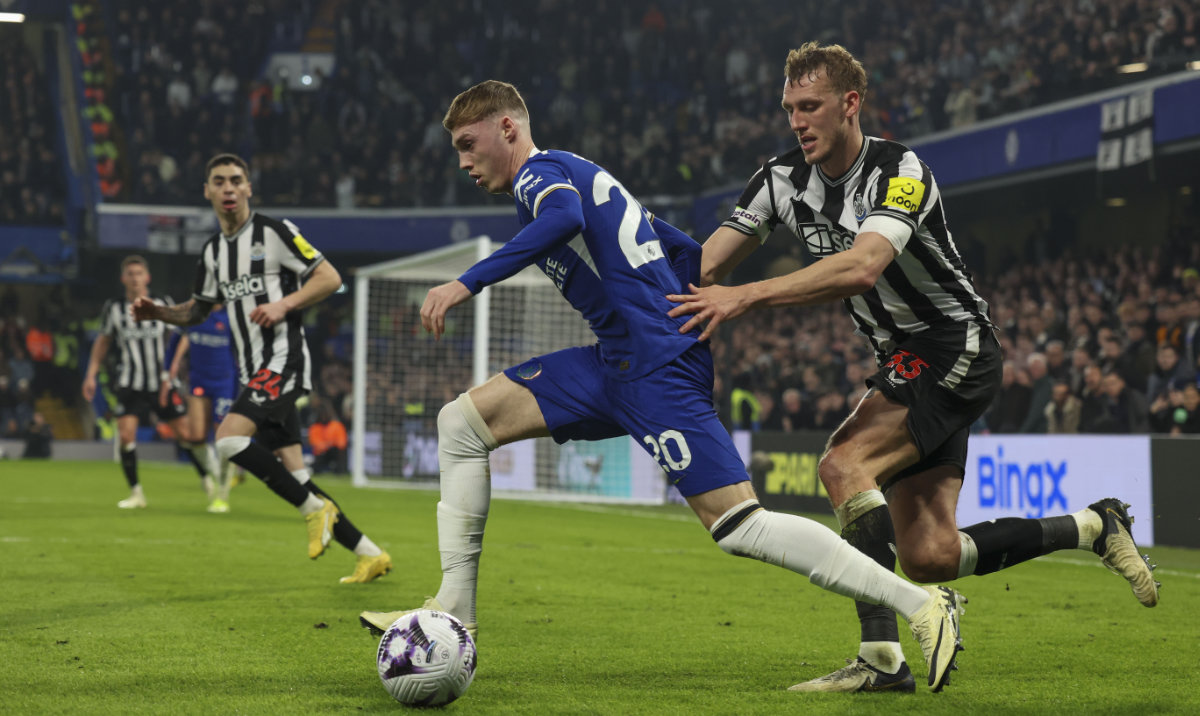 Newcastle’s Dan Burn, right, duels for the ball with Chelsea’s Cole Palmer during the English Premier League soccer match between Chelsea and Newcastle at Stamford Bridge stadium in London, March 11, 2024. (AP)