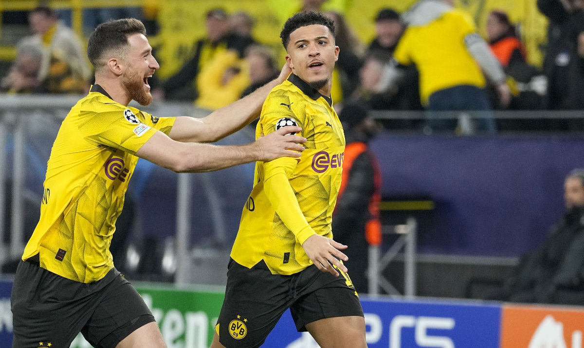 Dortmund's Jadon Sancho, right, celebrates with Dortmund's Salih Ozcan after scoring his side's opening goal during the Champions League round of 16 second leg soccer match between Borussia Dortmund and PSV Eindhoven at the Signal Iduna Park in Dortmund, Germany, March 13, 2024. (AP)