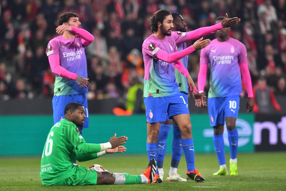 AC Milan’s French goalkeeper Mike Maignan and French midfielder Yacine Adli react during their UEFA Europa League round of 16 second leg match against Slavia Prague in Prague on Mar.14, 2024. (AFP)