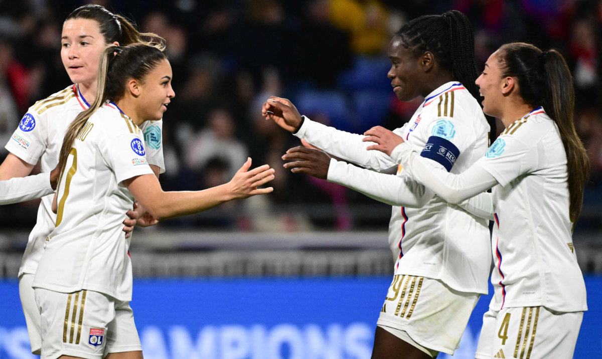 Lyon's French forward Delphine Cascarino (L) celebrates with teammates after scoring her team's second goal during the UEFA Women's Champions League quarterfinal second leg match between Olympique Lyonnais and SL Benfica on March 27, 2024. (AFP)
