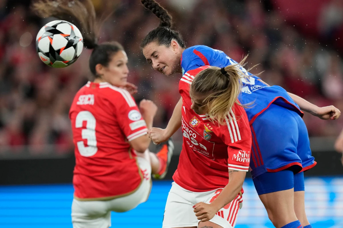 Lyon's Sara Daebritz, top right, scores her side's second goal during the women's Champions League quarterfinals, first leg, soccer match between SL Benfica and Olympique Lyonnais at the Luz Stadium, in Lisbon, Tuesday. (AP)