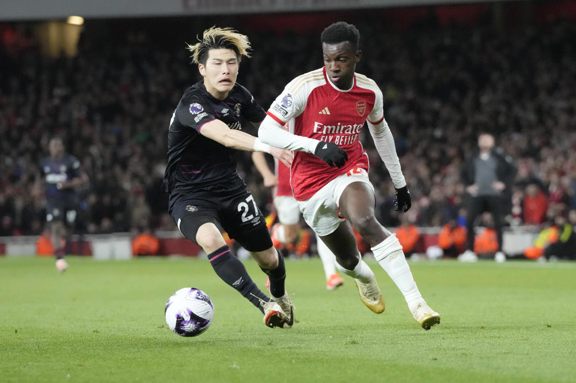 Luton Town's Daiki Hashioka, left, challenges for the ball with Arsenal's Eddie Nketiah during their English Premier League match at the Emirates Stadium on Apr. 3, 2024. (AP)