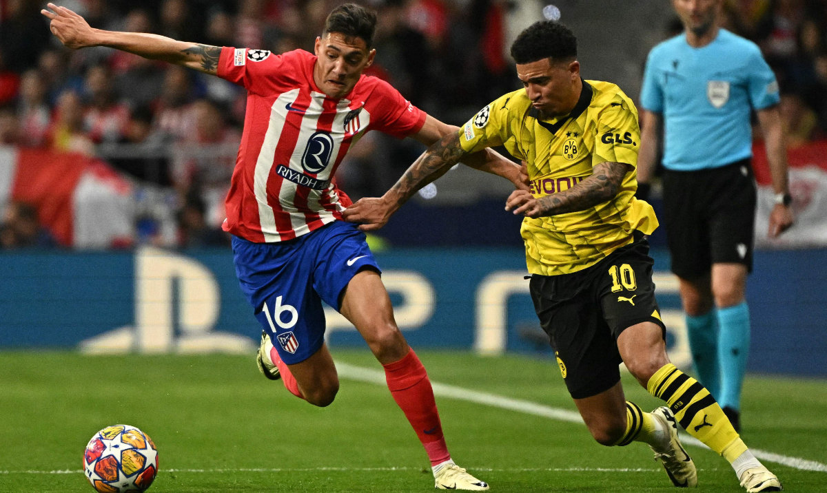 Atletico Madrid's Argentine defender Nahuel Molina (L) fights for the ball with Dortmund's English midfielder Jadon Sancho during the UEFA Champions League quarter final first leg football match between Club Atletico de Madrid and Borussia Dortmund in Madrid on April 10, 2024. (AFP)