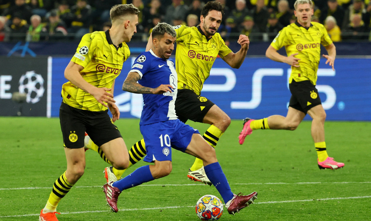 Atletico Madrid's Angel Correa in action with Borussia Dortmund's Mats Hummels and Nico Schlotterbeck during the Champions League quarterfinal second leg soccer match. (Reuters)