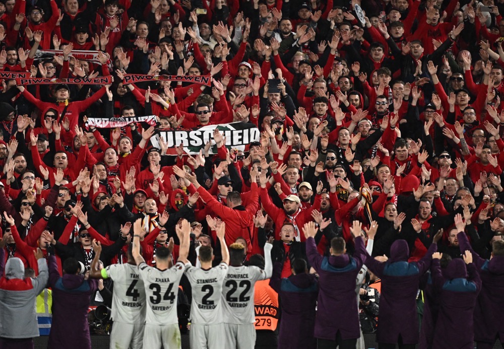 Bayer Leverkusen players celebrate with their fans after the match against West Ham. (Reuters)