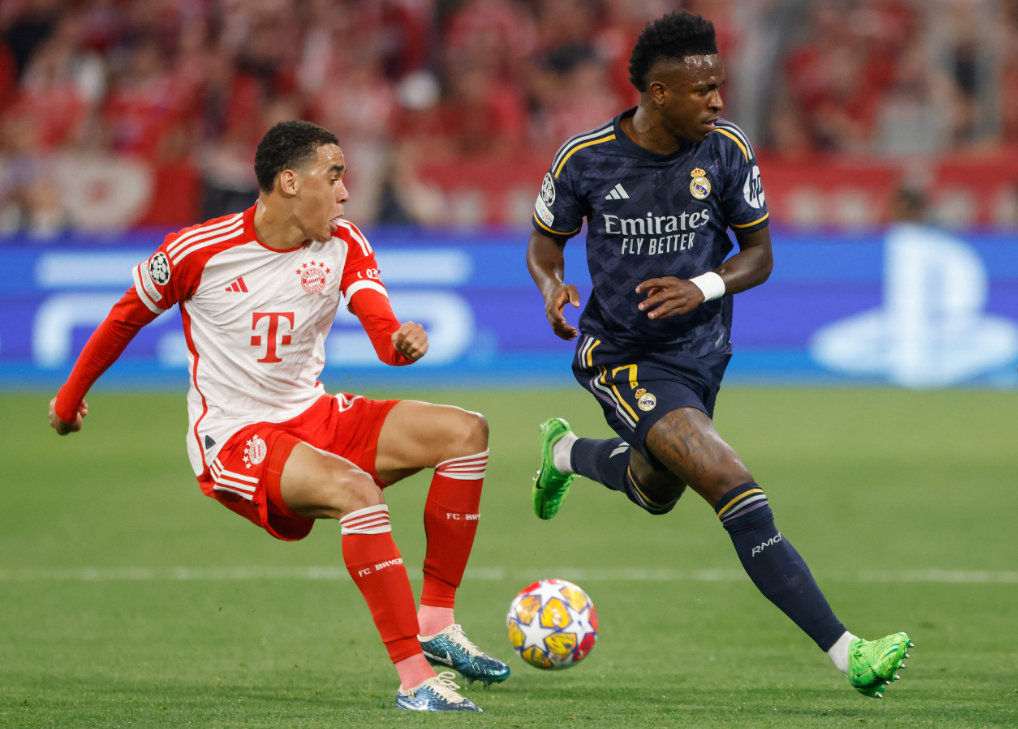 Bayern Munich's German midfielder Jamal Musiala (L) and Real Madrid's Brazilian forward Vinicius Junior vie for the ball during the UEFA Champions League semi-final first leg football match between FC Bayern Munich and Real Madrid CF on April 30, 2024 in Munich. (AFP)