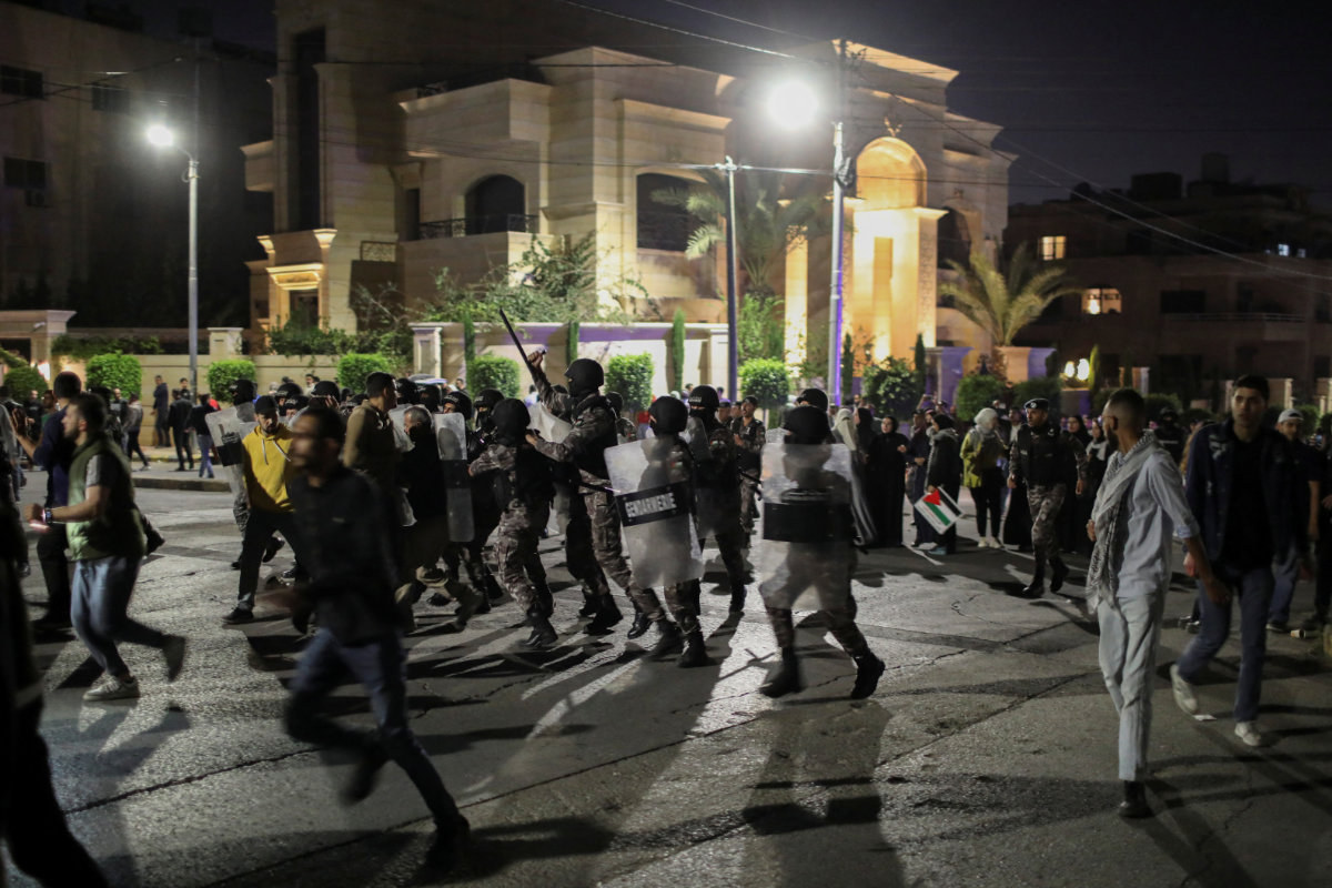 Jordanian police keep protesters away from the Israeli embassy in Amman on April 6, 2024, to prevent violence. (Reuters)