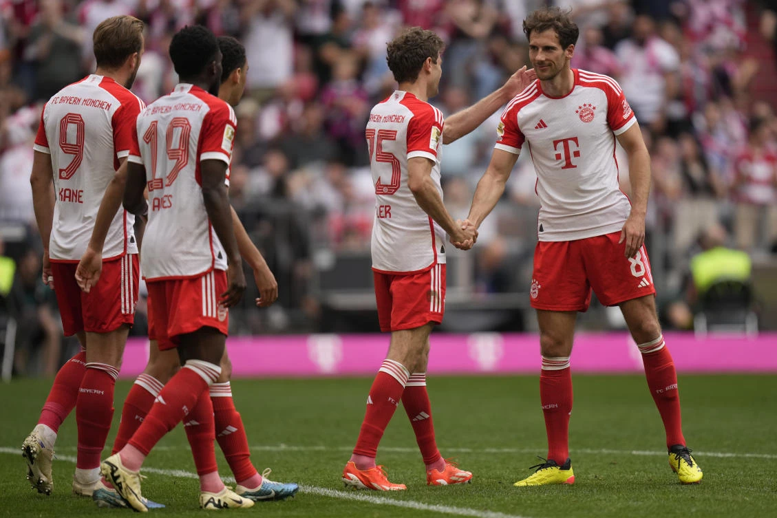 Bayern’s Thomas Mueller is congratulated by Leon Goretzka after scoring his side’s second goal during their Bundesliga match against Cologne at the Allianz Arena in Munich on Apr. 13, 2024. (AP)