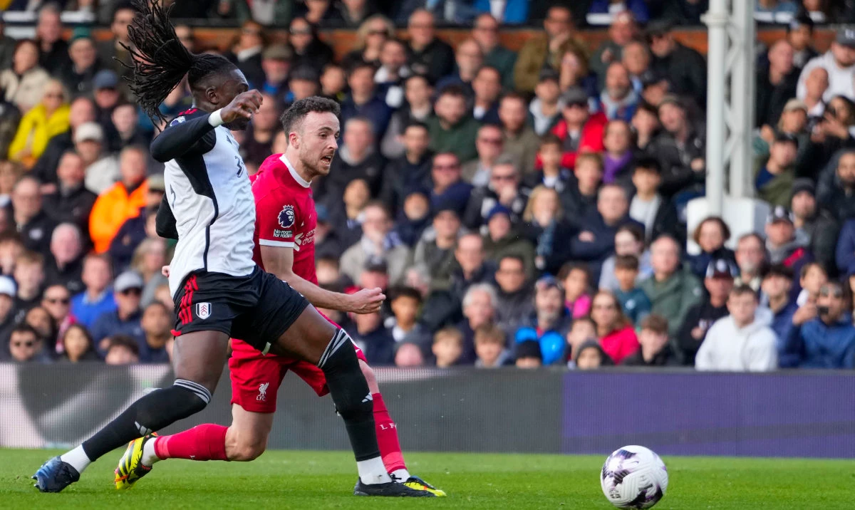 Liverpool's Diogo Jota scores his side's third goal during the English Premier League soccer match between Fulham and Liverpool at Craven Cottage stadium in London, Sunday. (AP)