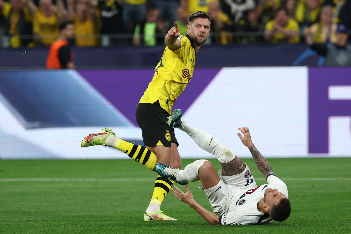 Dortmund's German forward Niclas Fuellkrug celebrates scoring the opening goal as Paris Saint-Germain's French defender Lucas Hernandez reacts during their UEFA Champions League semifinal first leg in Dortmund, western Germany on May 1, 2024. (AFP)