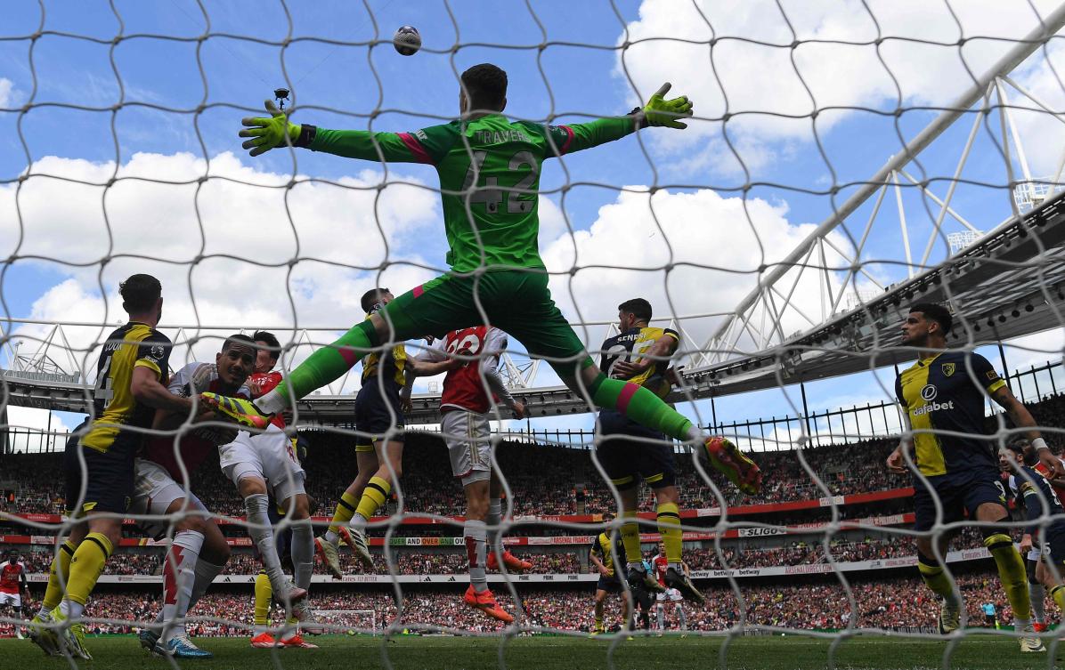 Bournemouth’s Irish goalkeeper Mark Travers jumps to defend a corner during their English Premier League match against Arsenal at the Emirates Stadium on May 4, 2024. (AFP)