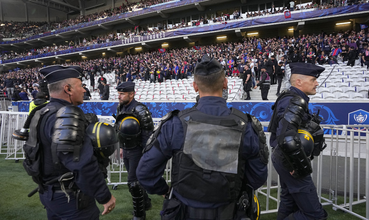 French riot police officers stand on the side of the pitch before the French Cup final soccer match between Lyon and PSG at the Pierre Mauroy stadium in Villeneuve d'Ascq, northern France, Saturday, May 25, 2024. (AP)
