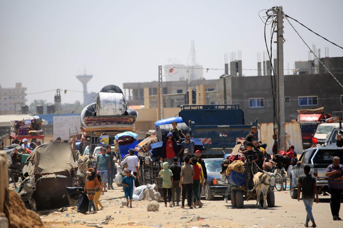 Palestinians transport their belongings as they flee the area of Tel Al-Sultan in Rafah in the southern Gaza Strip on May 30, 2024. (AFP)