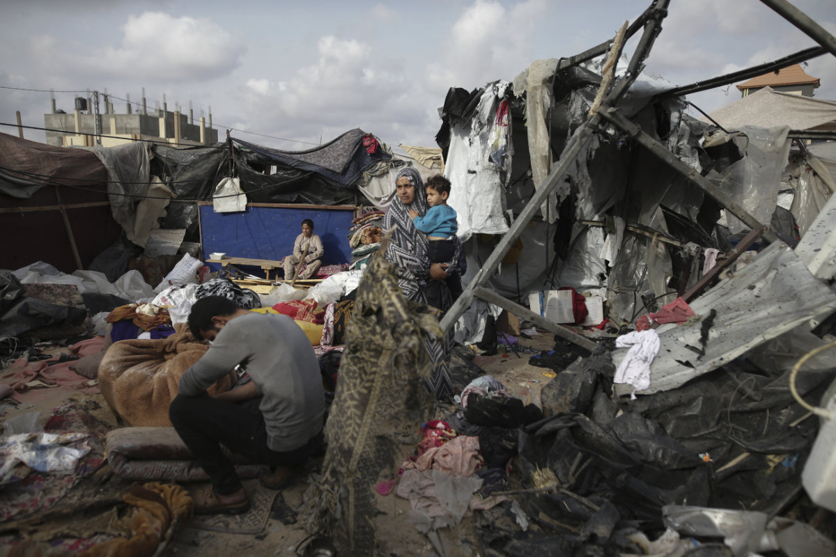 Displaced Palestinians inspect their tents destroyed by Israel's bombardment in Rafah on May 28, 2024. (AP)