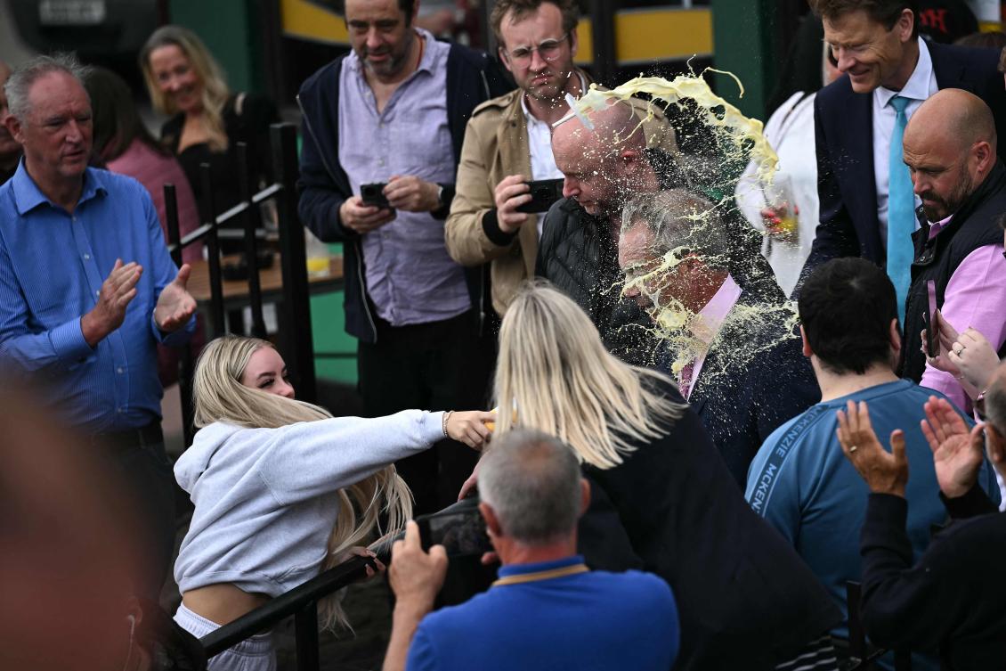 A person throws a drink in the face of newly appointed leader of Britain’s right-wing populist party, Reform UK, and the party’s parliamentary candidate for Clacton, Nigel Farage, during his general election campaign launch in Clacton-on-Sea, eastern England, on June 4, 2024. (AFP)