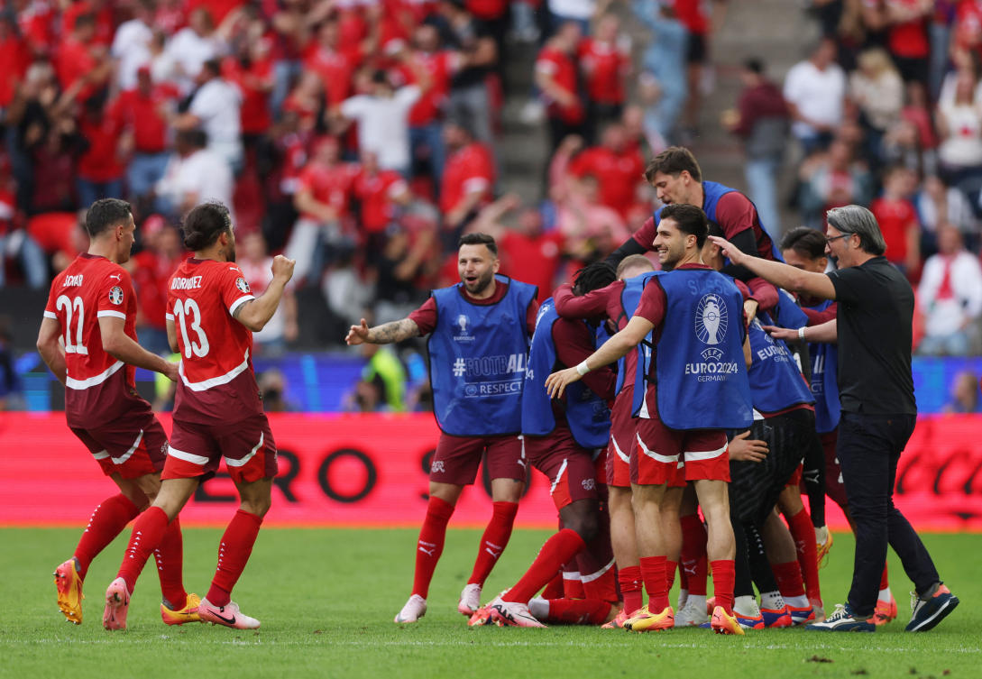 Switzerland’s Michel Aebischer celebrates scoring their second goal with teammates and coach Murat Yakin during their Euro 2024 — Group A — match against Hungary at Cologne Stadium, Cologne on Jun. 15, 2024. (Reuters)