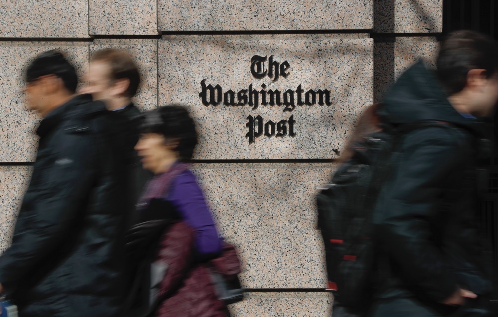 People walk by the One Franklin Square Building, home of The Washington Post newspaper, in downtown Washington. (AP)