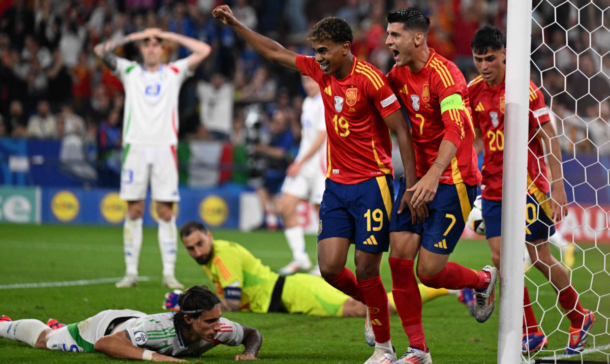 Spain's forward Lamine Yamal (C) and Spain's forward Alvaro Morata (center right) celebrate as Italy's defender Riccardo Calafiori (L) reacts after scoring an own goal during the UEFA Euro 2024 Group B football match between Spain and Italy at the Arena AufSchalke in Gelsenkirchen on June 20, 2024. (AFP)