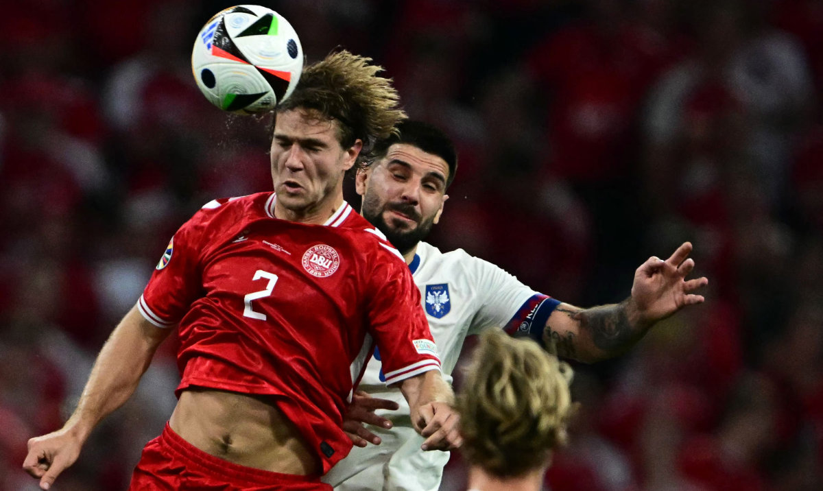 Denmark's defender #02 Joachim Andersen and Serbia's forward #09 Aleksandar Mitrovic jump for the ball during the UEFA Euro 2024 Group C football match between Denmark and Serbia at the Munich Football Arena in Munich on June 25, 2024. (AFP)