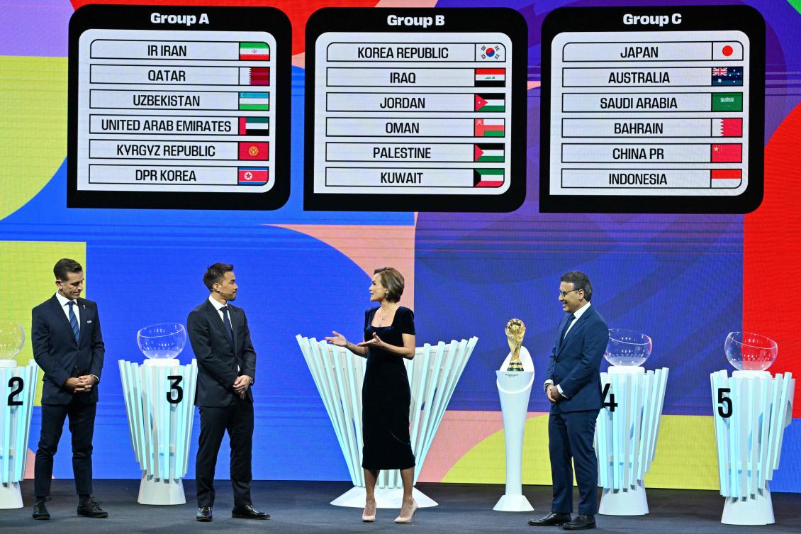 Japanese former footballer Shinji Okazaki (2nd L) and Iranian former footballer Mehdi Mahdavikia (R) stand on stage after the 2026 World Cup qualifying draw for Asian Football Confederation teams in Kuala Lumpur on Jun. 27, 2024. (AFP)