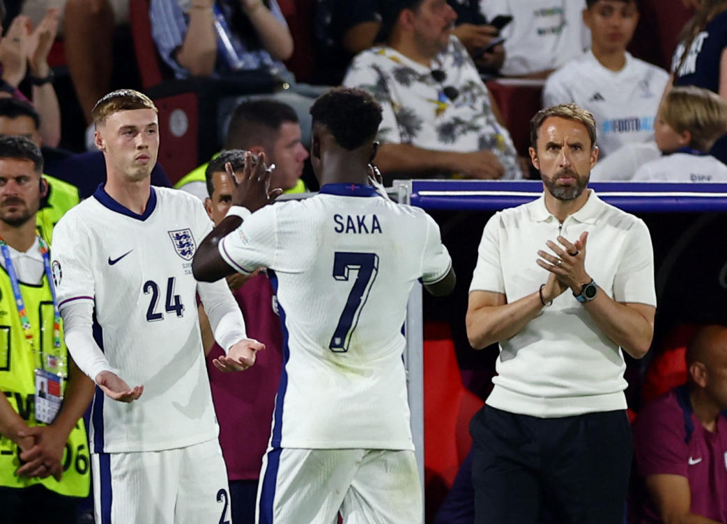 England’s Cole Palmer comes on as a substitute to replace Bukayo Saka as manager Gareth Southgate looks on during their Euro 2024 — Group C — match against Slovenia at Cologne Stadium, on June 25, 2024. (Reuters)