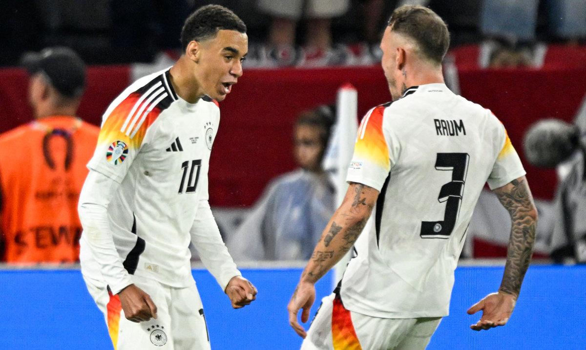 Germany's midfielder #10 Jamal Musiala celebrates with teammate defender #03 David Raum after scoring his team's second goal during the UEFA Euro 2024 round of 16 football match between Germany and Denmark at the BVB Stadion Dortmund in Dortmund on June 29, 2024. (AFP)