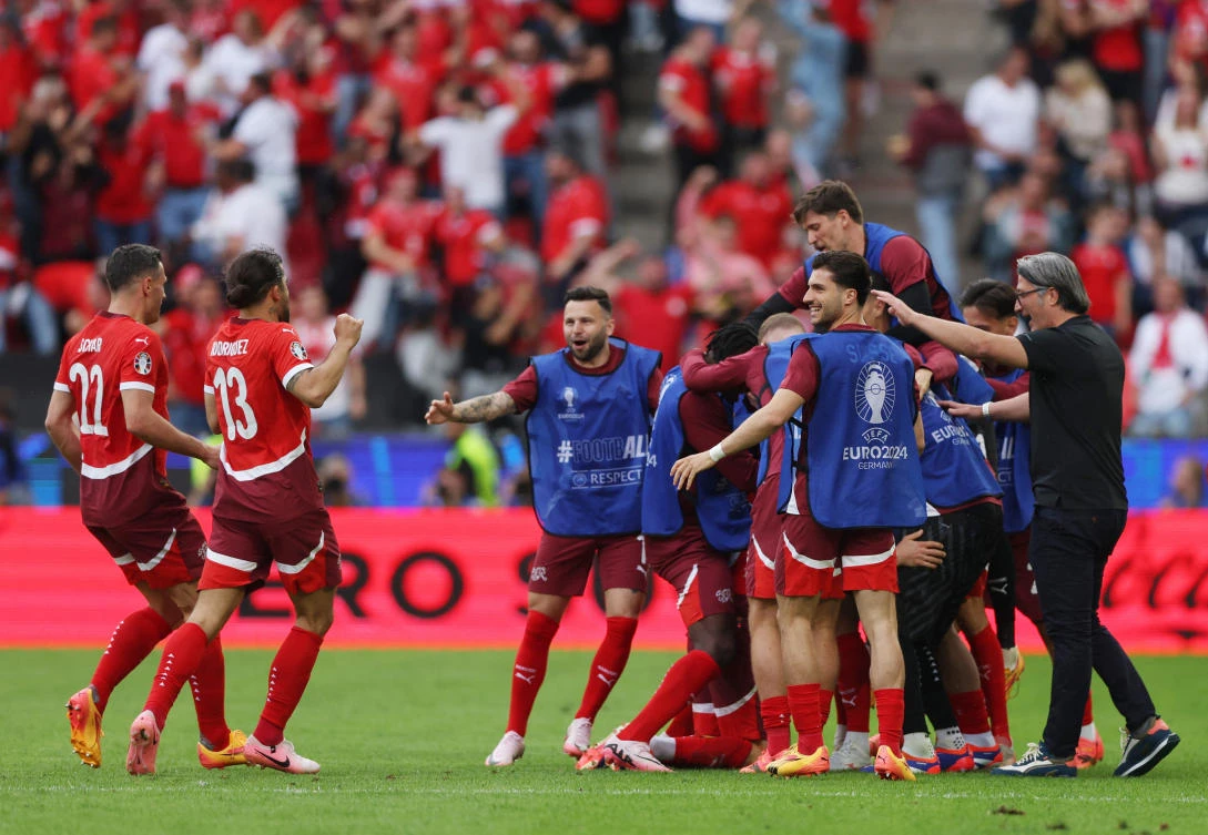 Switzerland’s Michel Aebischer celebrates scoring their second goal with teammates and coach Murat Yakin during their Euro 2024 — Group A — match against Hungary at Cologne Stadium, Cologne on Jun. 15, 2024. (Reuters)