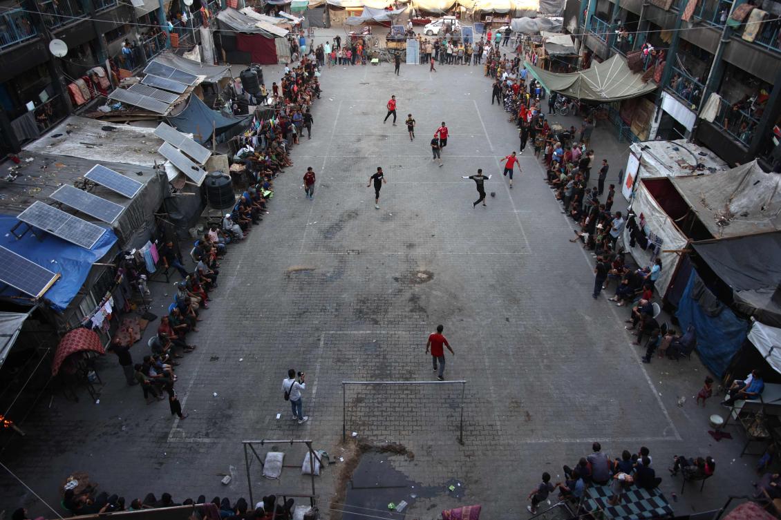 Displaced Palestinians play football in the courtyard of a UN-run school in Jabalia, in the northern Gaza Strip on Jul. 23, 2024. (AFP)