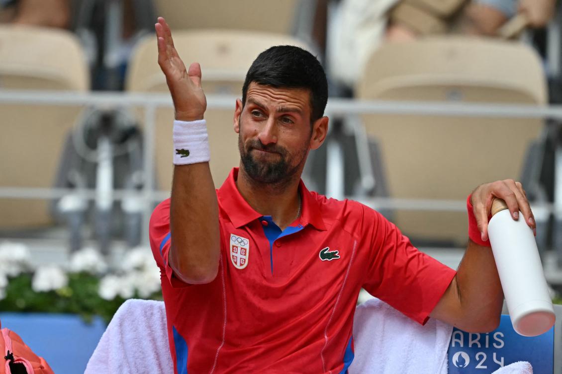 Serbia’s Novak Djokovic reacts in his seat during a break in play against Germany’s Dominik Koepfer during their men’s singles third round tennis match on Court Philippe-Chatrier at the Roland-Garros Stadium during the Paris 2024 Olympic Games on Jul. 31, 2024. (AFP)
