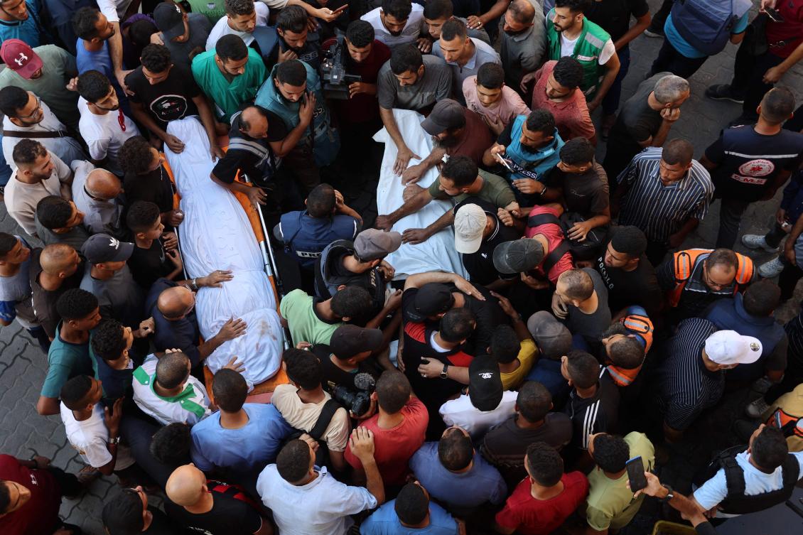 Mourners surround bodies of Al Jazeera Arabic journalist Ismail Al-Ghoul and cameraman Rami Al-Refee, killed in Israeli strike during their coverage of Gaza’s Al-Shati refugee camp, on July 31, 2024. (AFP)